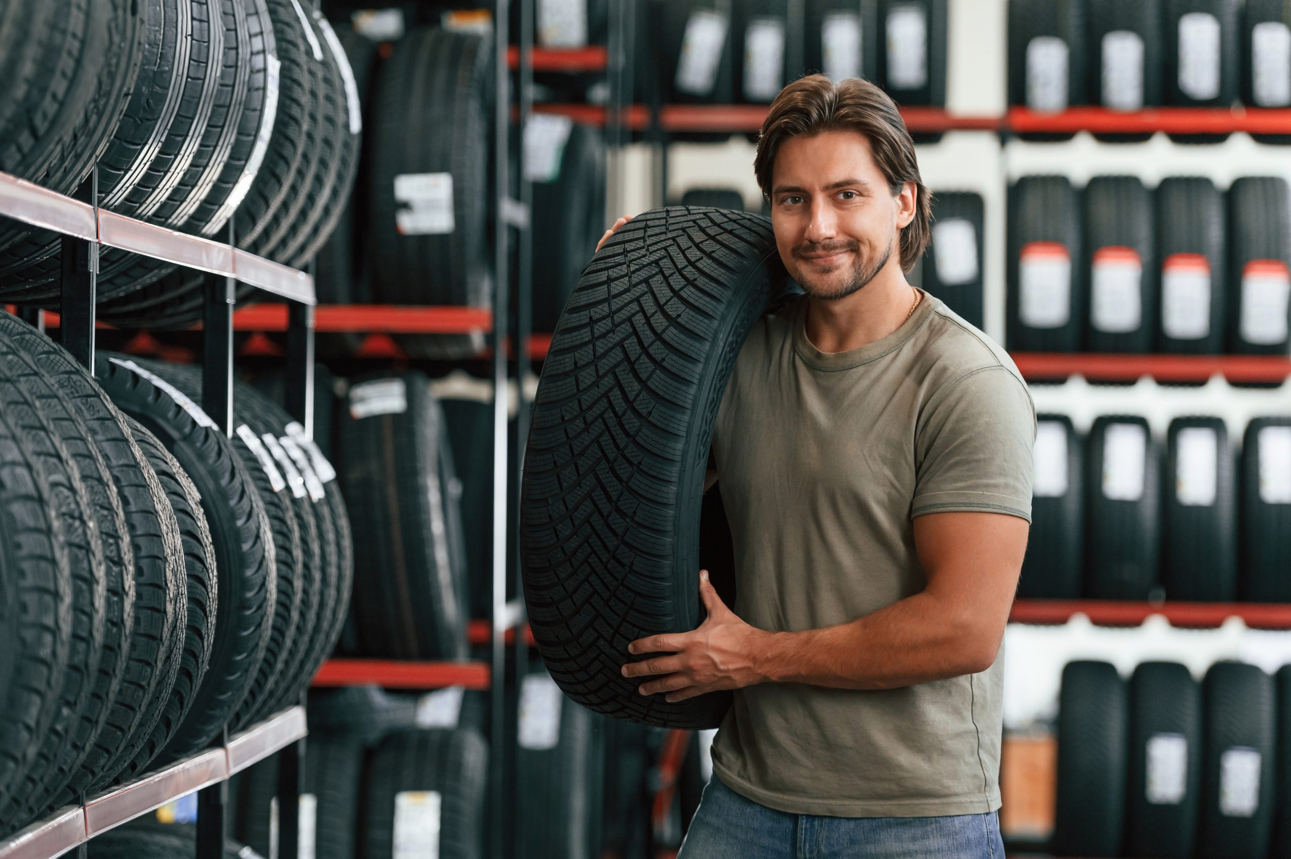Customer is choosing the tire. Man is in the tire fitting car service