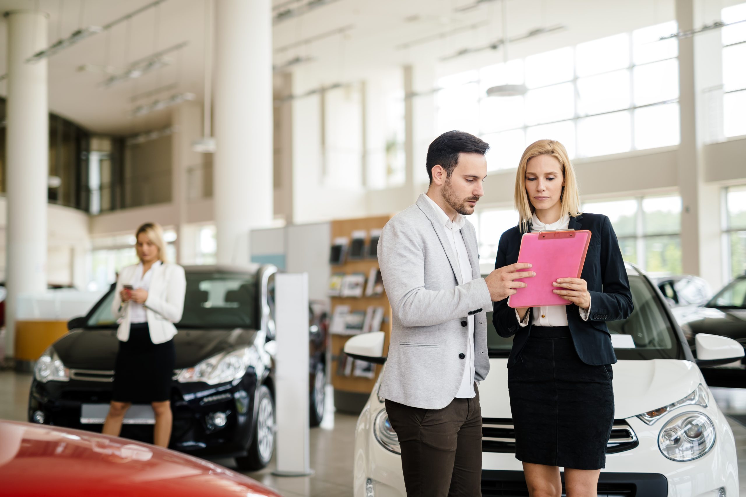 Salesperson working at car dealership